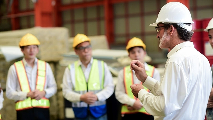 professional manager in hard hat meets with factory staff Mind the Gap: Communicating a Payroll Shift